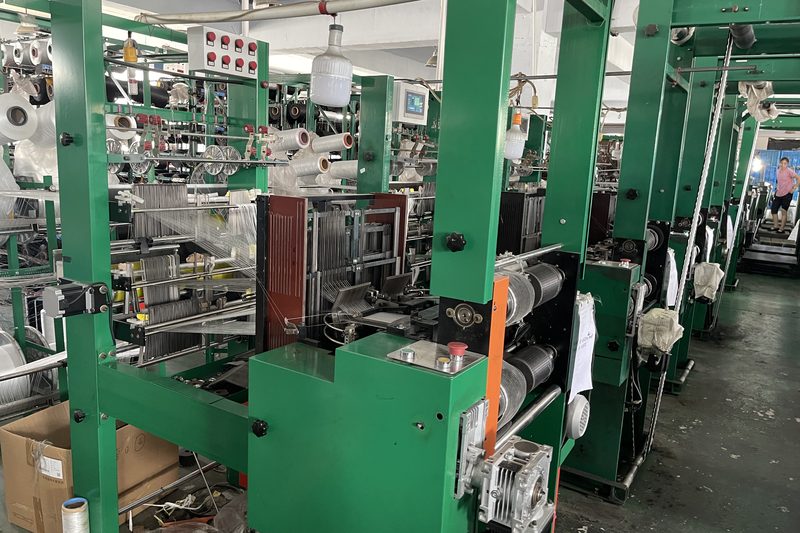 A row of braiding looms weaving pile on the production floor