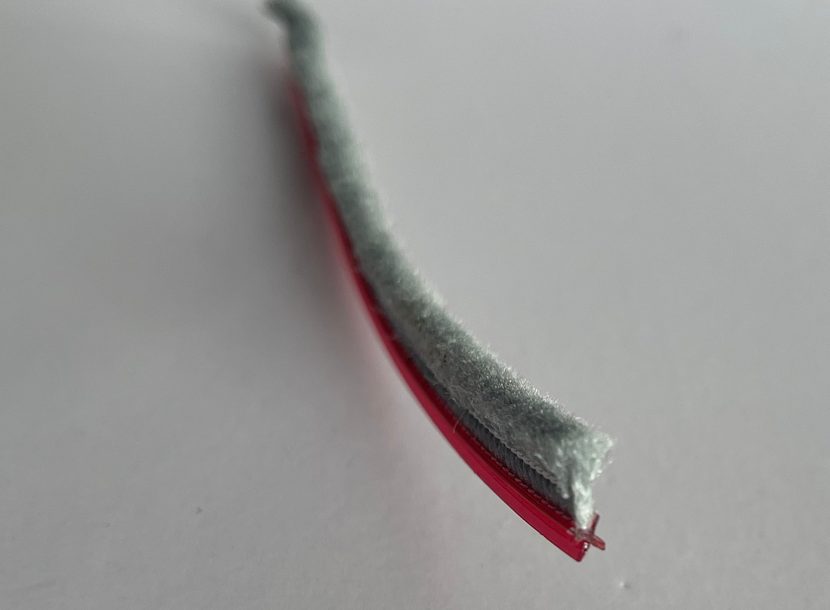 Cross-base strip with the shaped backing visible at the cut end.