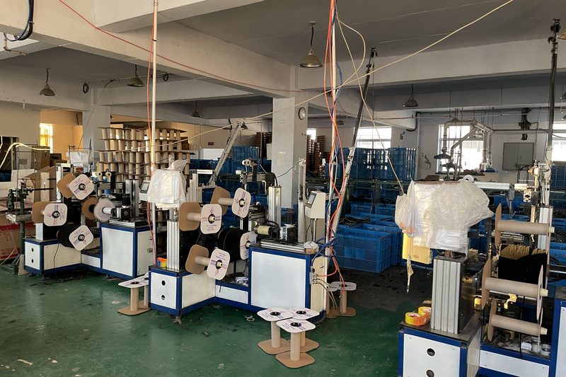 Spooling machines winding finished pile weatherstrip onto cores