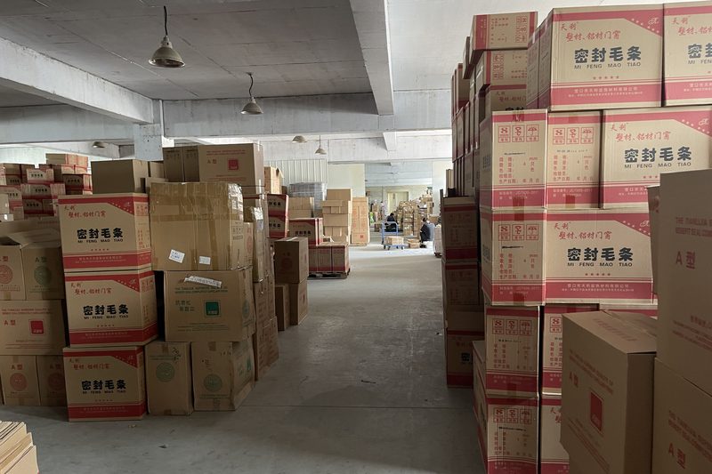 Cartons of finished pile weatherstrip stacked in the plant warehouse